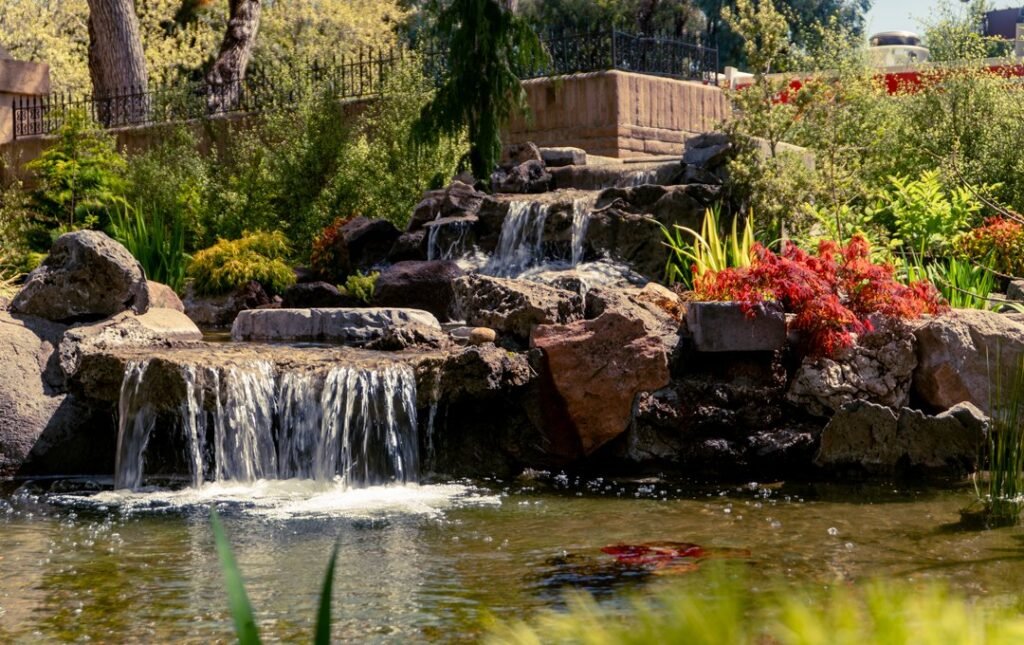 waterfall with lush greenery and flowers bay area.