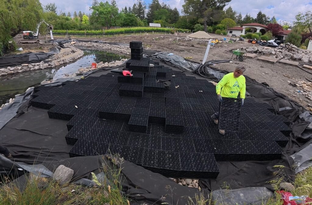 Man constructing wetland with aquablox and bioballs